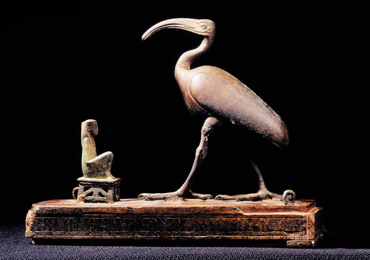 Bronze  and gilded wood model of ibis, with small bronze carving of goddess crouching  before it.