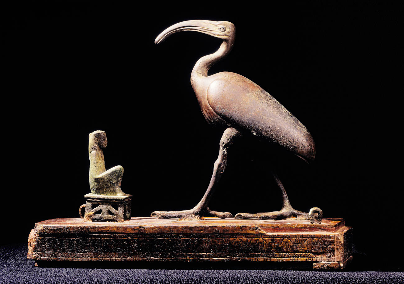Bronze and gilded wood model of ibis, with small bronze carving of goddess crouching before it.