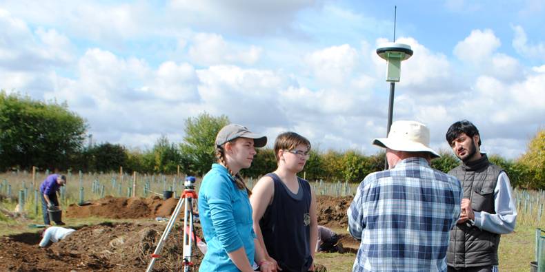 Students and volunteers learn to use a survey-grade GPS